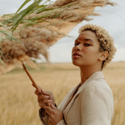 A Woman Holding an Umbrella with Grass