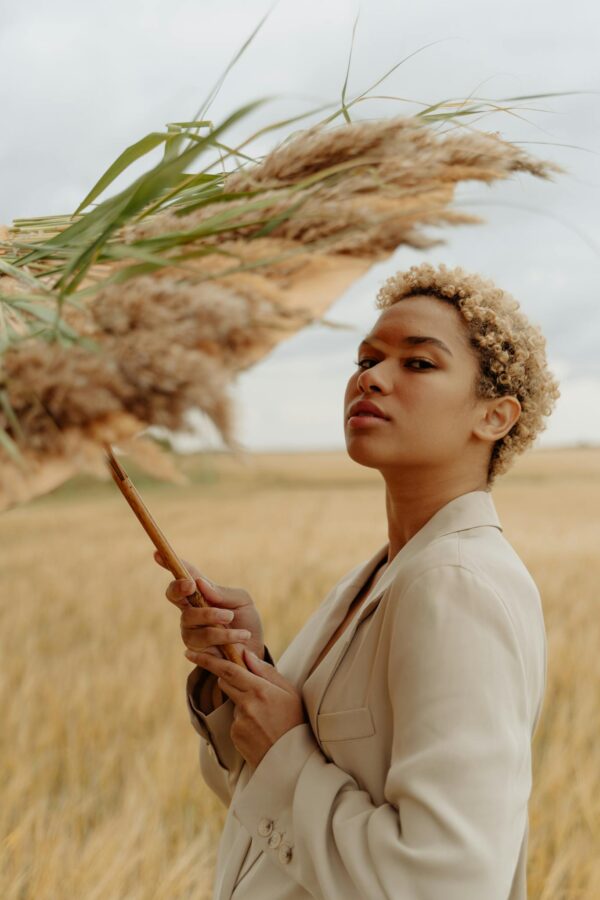 A Woman Holding an Umbrella with Grass