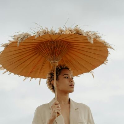 Woman in Beige Blazer Holding Brown Umbrella