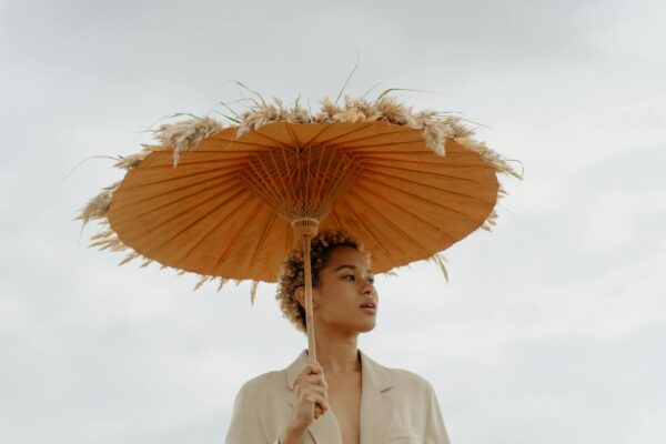 Woman in Beige Blazer Holding Brown Umbrella