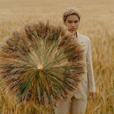 Woman on Meadow Holding Wheat Umbrella