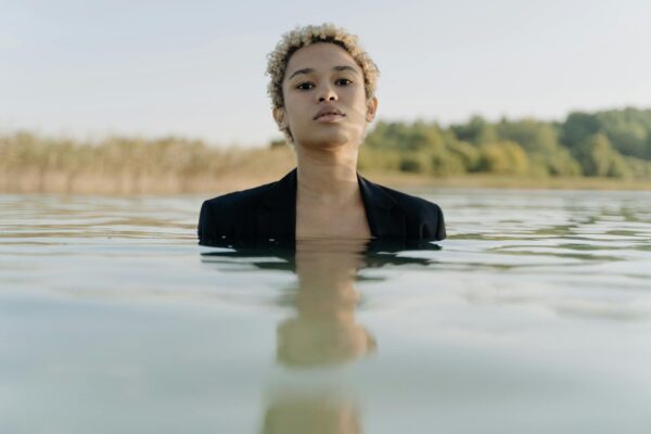 Woman Wearing Blazer Swimming on a Lake